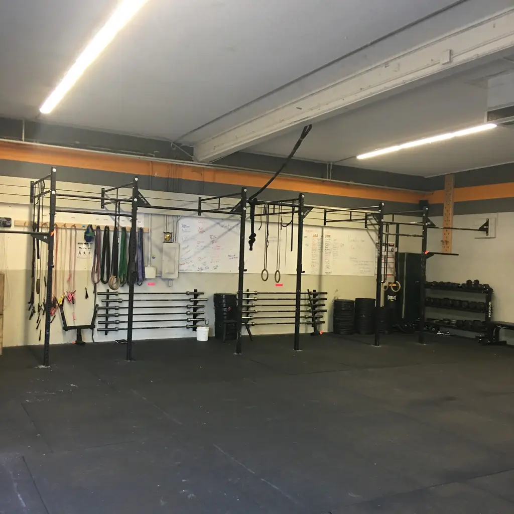 Rig wall, whiteboard and barbell storage inside CrossFit Almaden