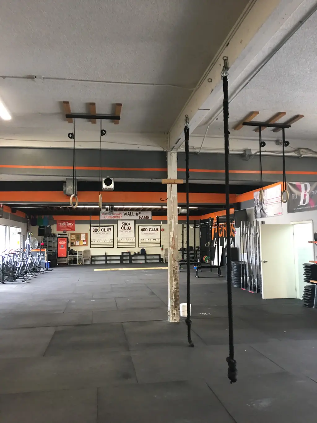 The community wall of fame at CrossFit Almaden showing the 300, 400 and 500-plus check-in club boards