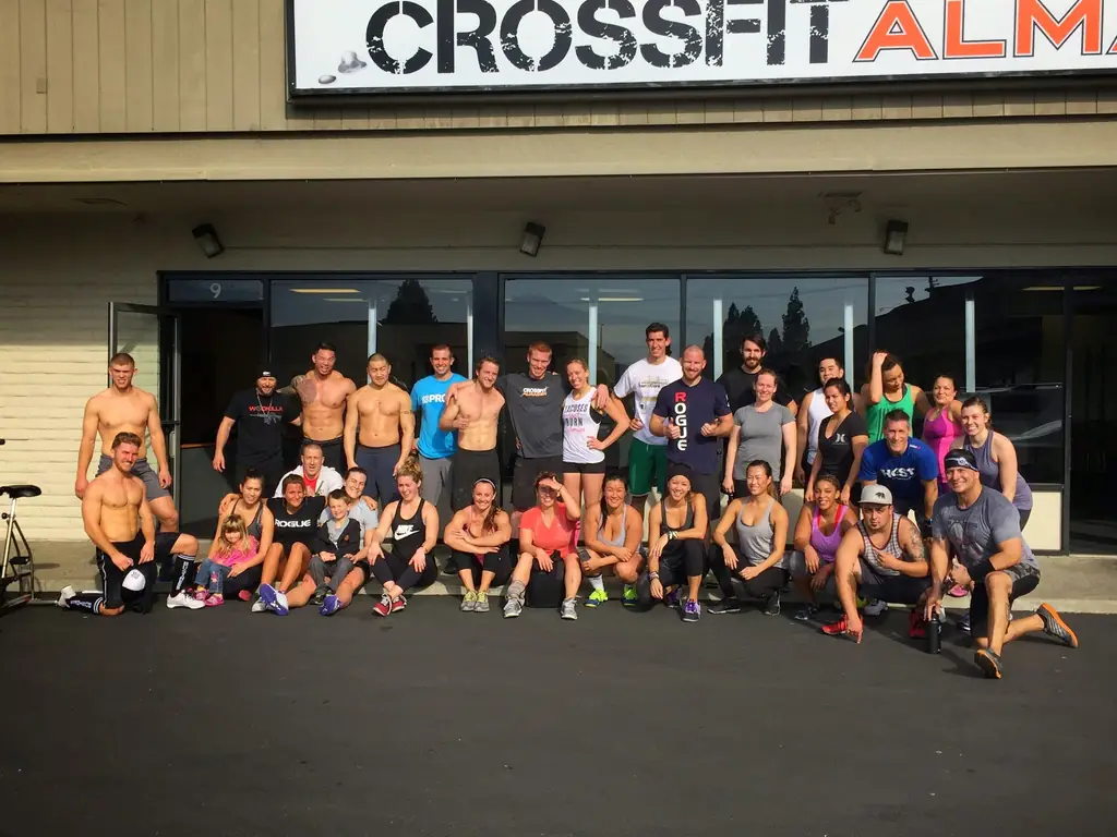 Members of CrossFit Almaden posed together as a group under the gym's sign